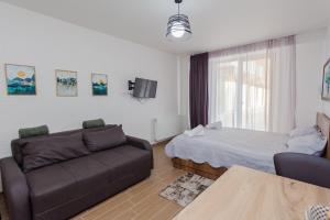 a living room with a couch and a bed at Ski In/Out Apartment in New Gudauri, Loft 2 in Gudauri