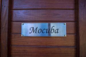 a sign on a wooden door with the word morocco at Ossanzaia Bilene Lodge in Vila Praia Do Bilene
