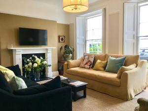 a living room with a couch and a fireplace at 'the inlet' falmouth in Falmouth