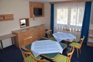 a room with two tables and chairs and a kitchen at Haus Valentin in Heiligenblut