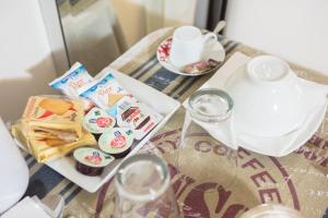 a table with a plate of food and a teapot at Residenza Alexander Guest House in Rome