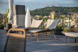 a group of chairs sitting on top of a roof at Silken Ramblas in Barcelona