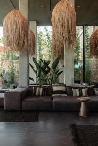 a living room with a couch and large windows at OKU Ibiza in San Antonio