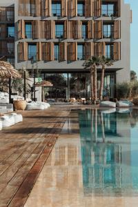 a hotel with a swimming pool and a building at OKU Ibiza in San Antonio