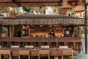 a bar at a restaurant with a man behind the bar at OKU Ibiza in San Antonio