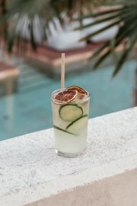 a drink sitting on a table next to a pool at OKU Ibiza in San Antonio