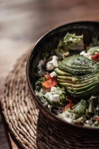 a bowl of food with cucumbers and other vegetables at OKU Ibiza in San Antonio