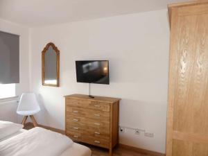 a bedroom with a bed and a television on a dresser at FeWo Zum Kuhturm in Günzburg