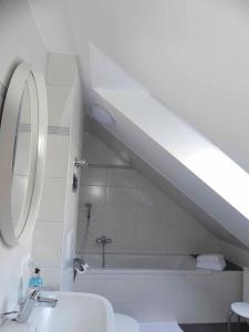 a bathroom with a sink and a bath tub at FeWo Zum Kuhturm in Günzburg +14 photos