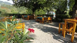 a group of wooden tables and benches and a flower at Ennstalerhof in Grossraming