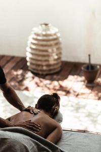 a woman getting a massage in a bath tub at OKU Ibiza in San Antonio