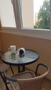a glass table with a cup and a bowl of fruit at Vacation in druskininkai in Druskininkai +6 photos