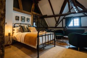 a bedroom with a bed in a room with beams at Old Infirmary in Worcester