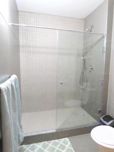 a shower with a glass door in a bathroom at Embassy Gardens 17 West Rd South Morningside Sandton Johannesburg Secure 2 Bedroom fully furnished apartment with 24hrs security in Johannesburg