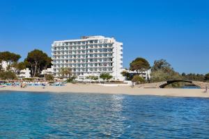 a hotel on the beach next to a beach at Universal Hotel Castell Royal in Canyamel
