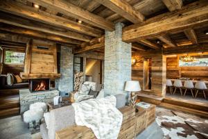 een woonkamer met een stenen open haard en een bank bij HelloChalet - Chalet Seventy One - Larger Family Ski Chalet in the center in Valtournenche