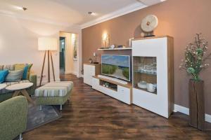 a living room with a couch and a tv at Villa Waldstr. App 14 in Bansin