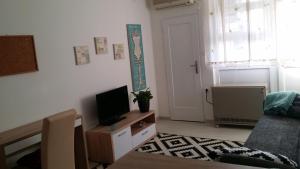 a living room with a tv on a dresser at Apartment Marina in Vinkovci