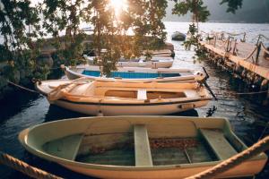 a row of boats tied to a dock in the water at Eco Hotel Carrubba in Tivat