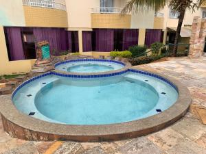 a large swimming pool in the middle of a building at Flat em Caldas Novas in Caldas Novas