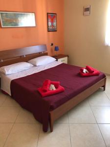 a bedroom with a bed with red towels on it at Attico Rosa in Gioia Tauro
