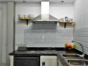 a kitchen with a sink and a stove at Bungalow Marbella (San Pedro Alcantara) in Marbella
