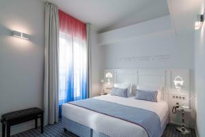 a hotel room with a large bed and a large window at Hotel 34B - Astotel in Paris