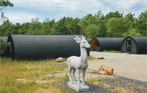 a statue of a giraffe standing in a field at Stunning Apartment In Nørre Nebel in Nørre Nebel