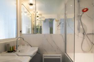 a bathroom with a sink, toilet and shower at Hotel 34B - Astotel in Paris