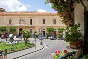 a large building with a street in front of it at Villa Elisa Holiday Home in Sorrento