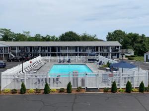 a hotel with a large pool in front of a building at The Tidewater Inn - Cape Cod in West Yarmouth