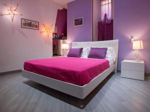 a bedroom with a pink bedspread and a white bedspread at I Coralli rooms & apartments in Monterosso al Mare