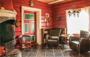 uma sala de estar com paredes e cadeiras vermelhas e uma lareira em Beautiful Home In Tynset With Kitchen em Tynset