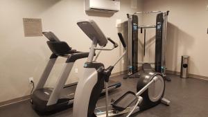 a gym with two exercise bikes in a room at Country Inn & Suites by Radisson, Savannah Midtown, GA in Savannah