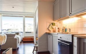 een keuken met witte kasten en een woonkamer bij Stunning Apartment In Hovden I Setesdal With House A Mountain View in Hovden