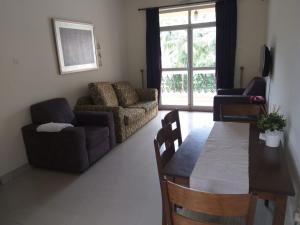 a living room with a table and a couch at River view apartments in Cavelossim