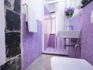 a bathroom with a sink, toilet, and window at I Coralli rooms & apartments in Monterosso al Mare