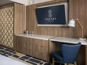 a hotel room with a tv on a wall at SAHARA Las Vegas in Las Vegas