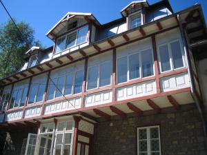 a large building with windows on top of it at Casa Valea Iancului SINAIA in Sinaia