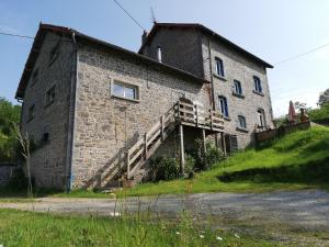 an old stone building on a hill with a staircase at La Maison Bleue23 in Sardent +12 photos