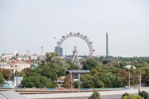 ein Riesenrad im Hintergrund einer Stadt in der Unterkunft Yourapartment Prater in Wien