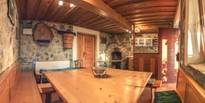 a dining room with a wooden table in a room at Vineyard Cottage Urban in Mirna