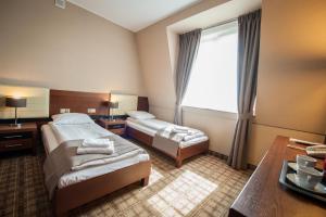 Łóżko lub łóżka w pokoju w obiekcie Hotel Rudnik