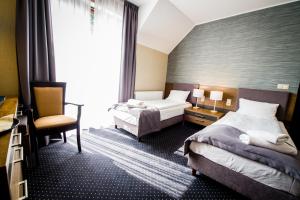 Łóżko lub łóżka w pokoju w obiekcie Hotel Rudnik