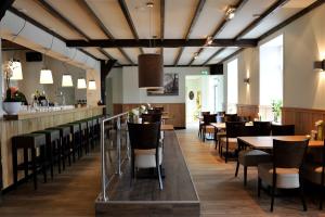 a restaurant with tables and chairs and a bar at Olmenduin No. 49 in Serooskerke