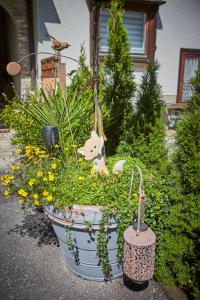 a planter filled with flowers and plants in front of a house at Landhaus Eberharter in Saalbach Hinterglemm