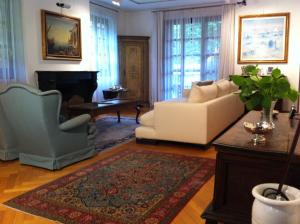 ein Wohnzimmer mit einem Sofa und 2 Stühlen in der Unterkunft Villa Camilla in Monza