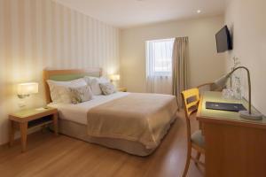 Кровать или кровати в номере Luna Esperanca Centro Hotel