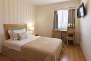 Кровать или кровати в номере Luna Esperanca Centro Hotel +26 фотографий