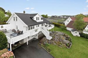 an aerial view of a white house with a staircase at Family house close to the beach in Mosterhamn